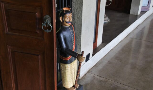 figurine, wooden, one, the door, under the roof, entrance, wall, male, travel, furniture, interior design, wood, mood, hotel, hall, rough, gray, figure, the structure of the, the style of the country, decorative, ornament, uniform, guardian