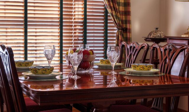 dinner table, table, chairs, soup bowls, china, plates, stemware, goblets, chippendale, fruit bowl, place setting, dining, glasses, placemats, wooden blinds, tableware, brown table, brown glass, brown fruits, brown dinner, brown glasses, dinner table, dinner table, dinner table, dinner table, dinner table, wooden blinds, wooden blinds