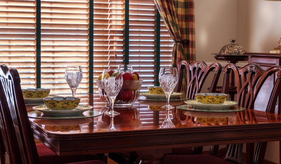dinner table, table, chairs, soup bowls, china, plates, stemware, goblets, chippendale, fruit bowl, place setting, dining, glasses, placemats, wooden blinds, tableware, brown table, brown glass, brown fruits, brown dinner, brown glasses, dinner table, dinner table, dinner table, dinner table, dinner table, wooden blinds, wooden blinds